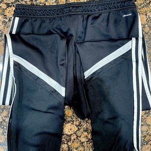 Adidas black and white Track pants with zipper ankle closure.